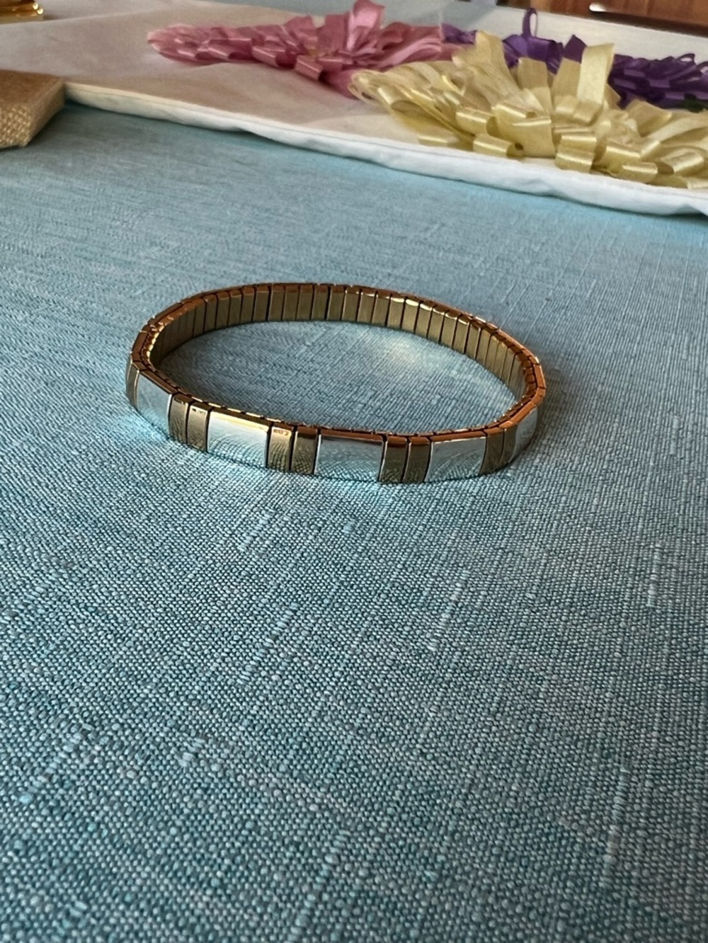 Polished gold and silver tone metal expansion bracelet